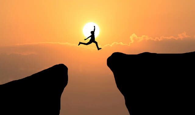 courage man jump through gap hill business concept idea